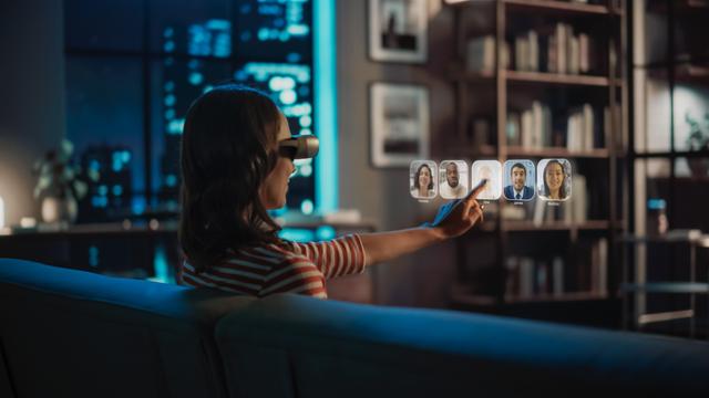 Woman using virtual reality headset at home