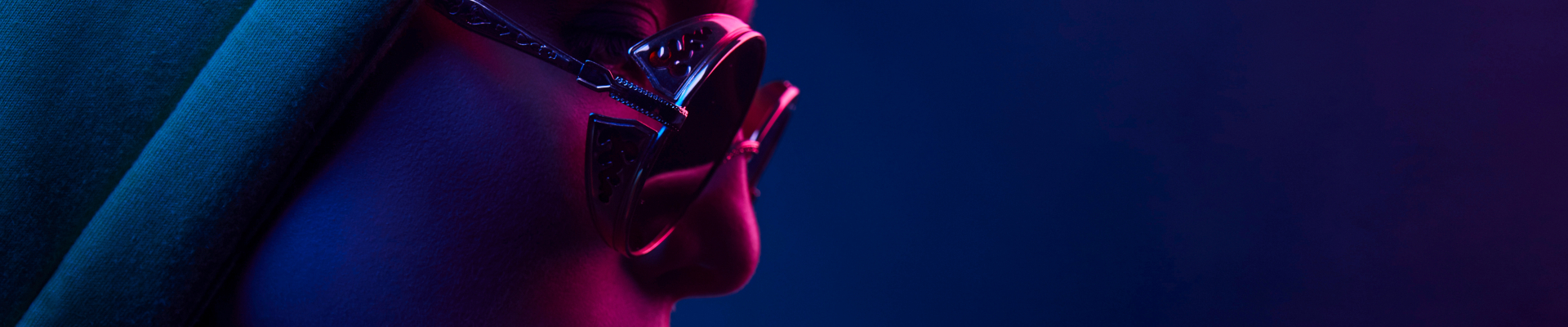 Neon close up of woman in round sunglasses