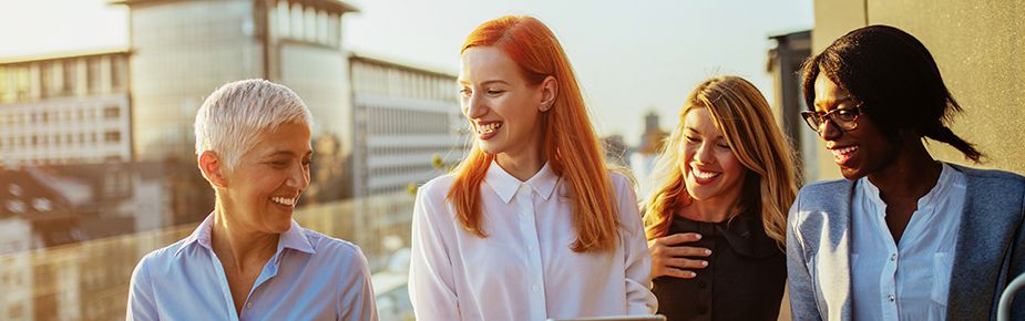 Header-four-women-in-sunset-lit-place