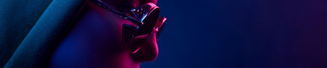 Neon close up of woman in round sunglasses
