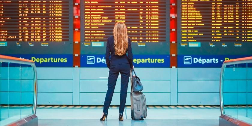 business woman with hand luggage in international airport terminal