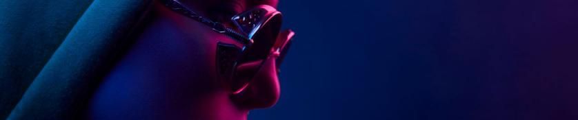 Neon close up of woman in round sunglasses