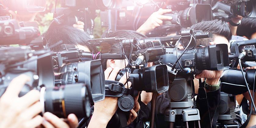 press and media camera ,video photographer on duty in public news coverage event for reporter and mass media communication