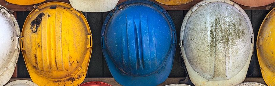 old and worn colourful hard hats