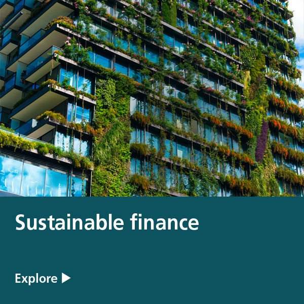 sustainable finance - housing flats with green shrubs