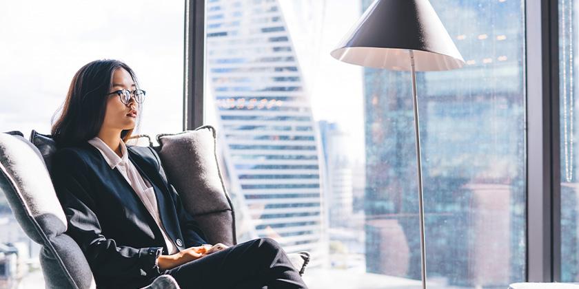 businesswoman in chair near window 840x420.jpg