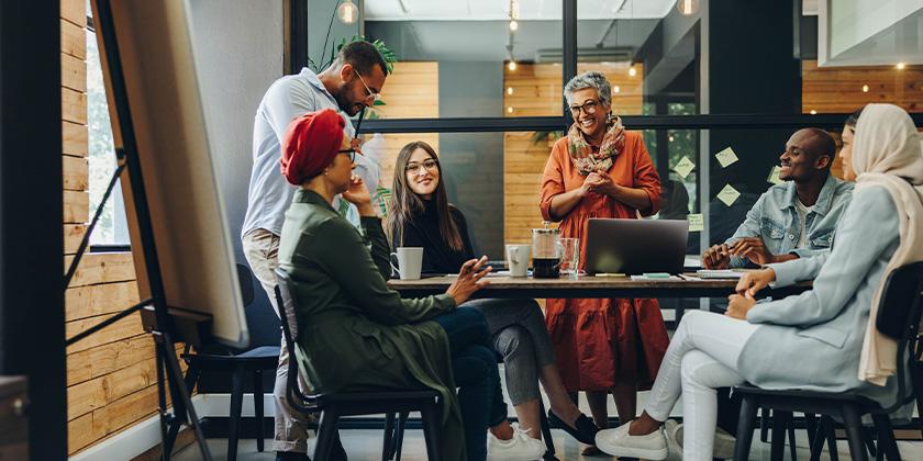 Happy businesspeople in creative office 840x420.jpg