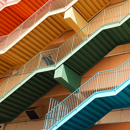 Colorful stairs in front of orange building