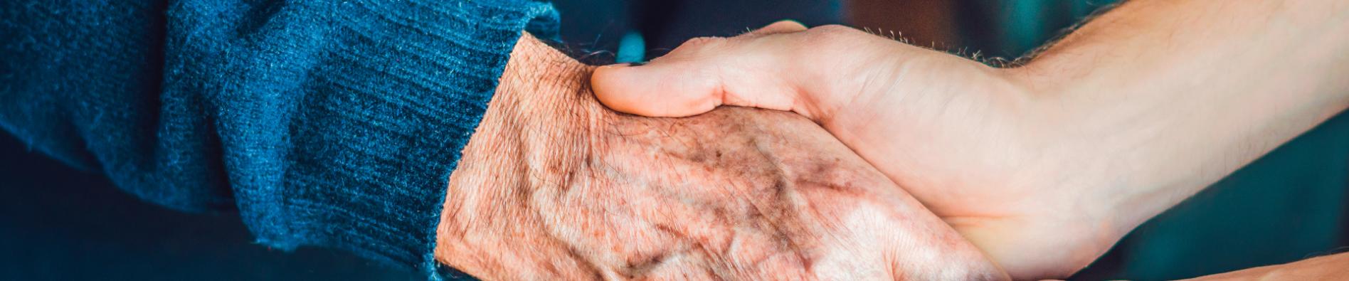 Hands of an old woman and a young man