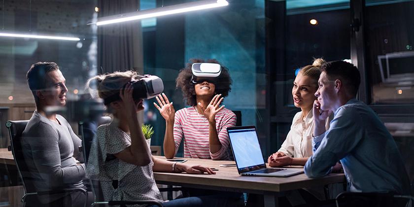 group of people looking through virtual reality goggles