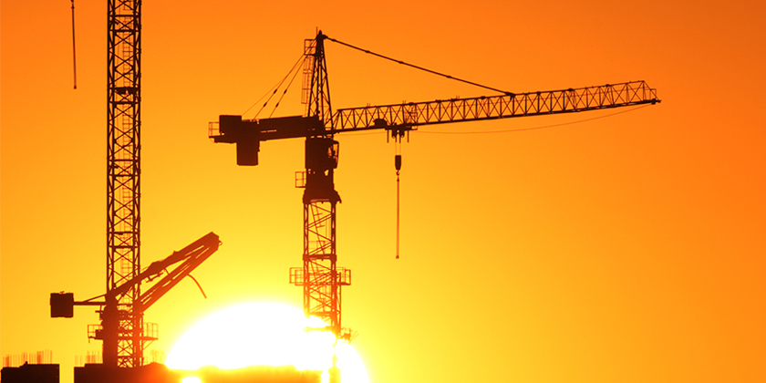 Cranes with orange sky