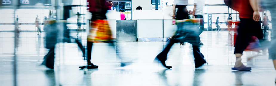 blurred shoppers walking in shopping mall