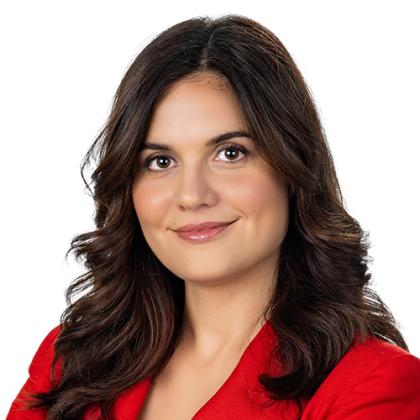 portrait of Tamara Zejak, she is having long brown hair and a red blazer on