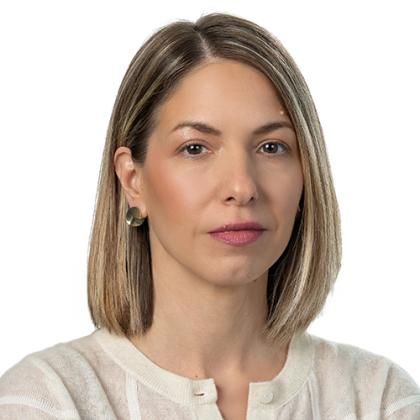 Portrait of Marija Marošan, she is having a blond, brunette bob and a light creme colored cardigan on.