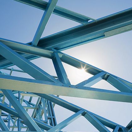 new residential construction home metal framing against a blue sky