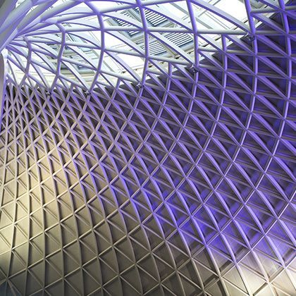 view at purple lighted kings cross station ceiling in london
