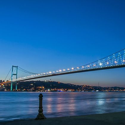 bosporus bridge at night in istanbul, turkey