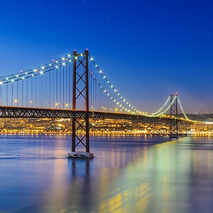night view of lisbon and of the 25 de abril bridge, portugal