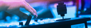 womans hand on a joy stick on media editing deck