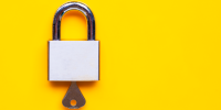 Lock and key on yellow background