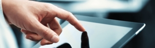 businessman's finger touching a tablet screen