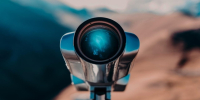 Binocular with view on mountains on background