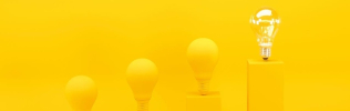 Light bulbs on yellow background 925x290