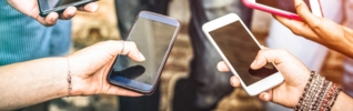 group of hands holding mobile phones