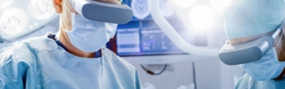 surgeons wearing virtual reality goggles in an operating theatre