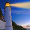 lighthouse at night with orange beam enhanced
