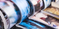 stack of open colourful magazines