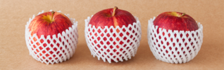 three red apples wrapped in white foam protective covering