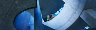 two women chatting over the side of a wall