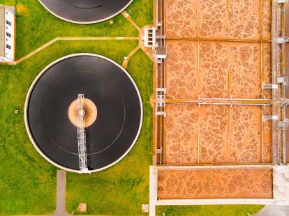Aerial view to biogas plant from sewage treatment in green fields