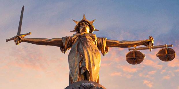 gold lady justice statue on the top of the old bailey in london