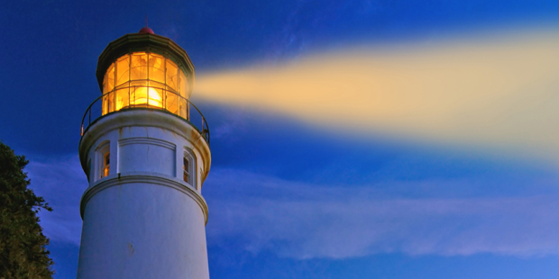 Lighthouse at night with light shining