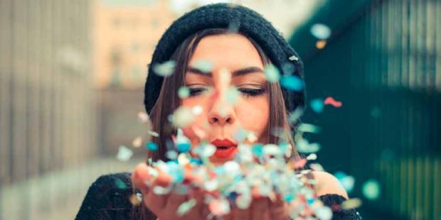 Women blowing petals from hands 840x420