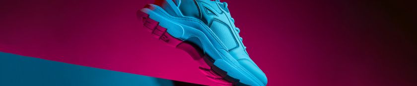 Sport shoes on neon background 1920x400.jpg