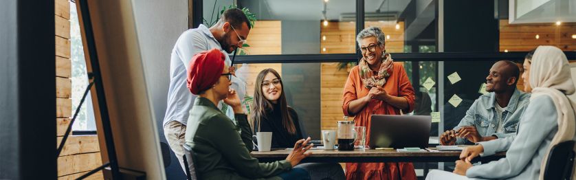 Happy businesspeople in creative office 1920x600.jpg