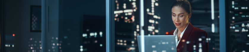 Businesswoman working late in a night city 1920x400.jpg