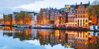 Night city view of Amsterdam, the Netherlands with Amstel river